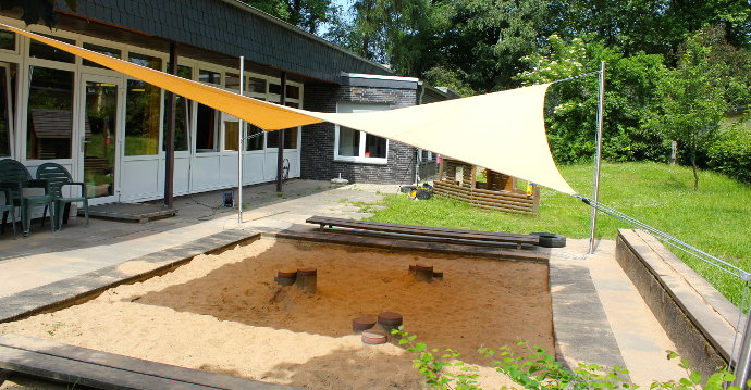 Sonnensegel in gelb über Sandkasten